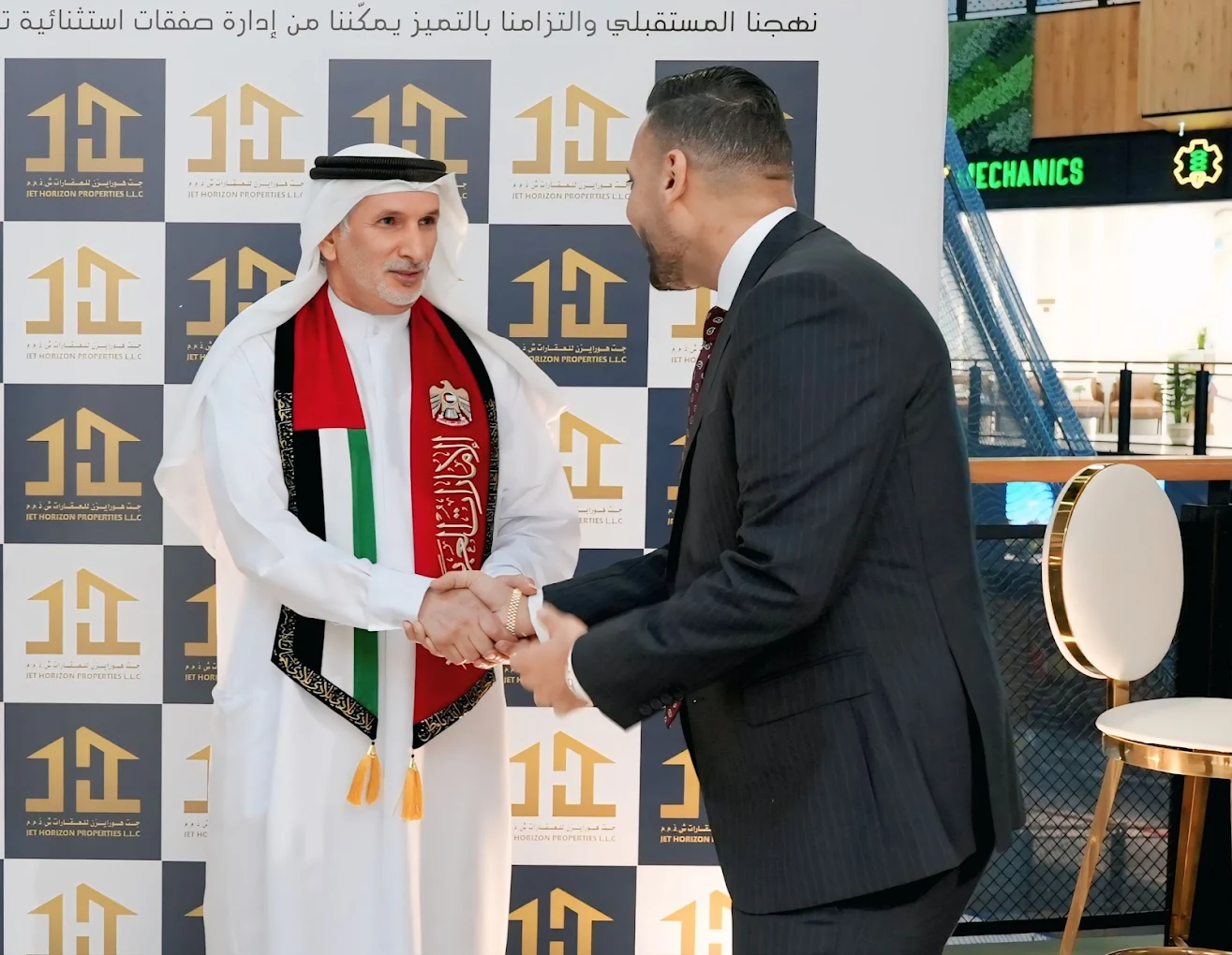 Jet Horizon Properties director shaking hands while receiving the Binghatti Recognition Award