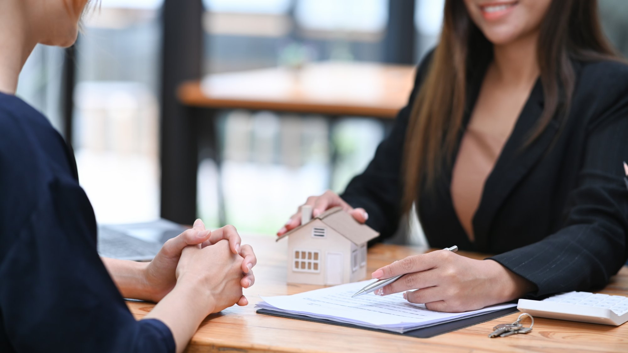 Property consultant reviewing a purchase agreement with a client in Dubai